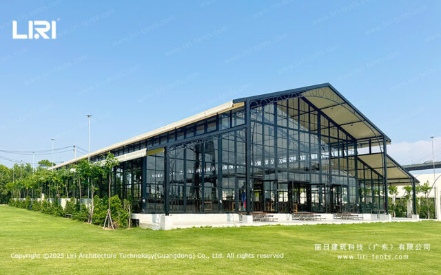 Orangery tent transparent exterior on a lawn with glass walls