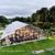 Orangery tent garden event exterior with glass walls and evening lighting