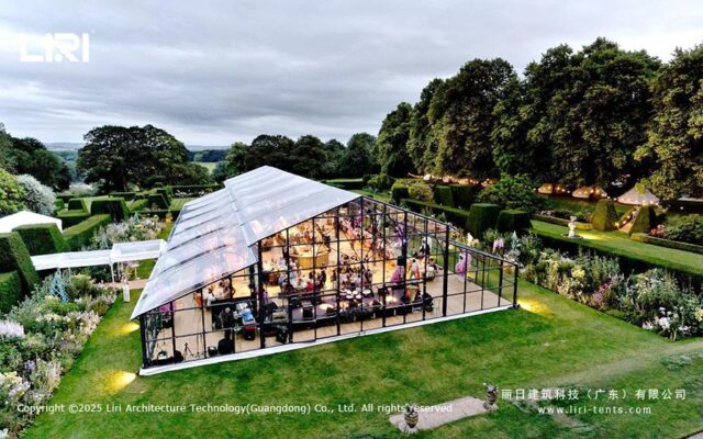Orangery tent garden event exterior with glass walls and evening lighting