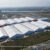 Aerial view of a large aluminum structure exhibition tent complex hosting a global expo