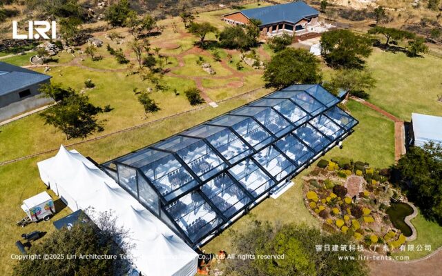 Orangery tent outdoor event aerial view with transparent roof and garden setting
