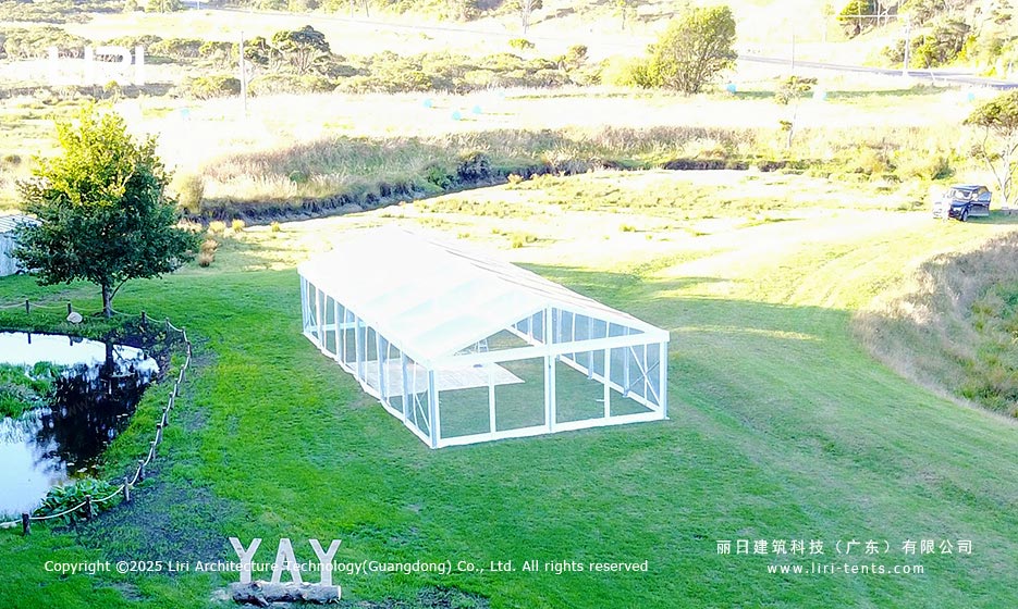 Clear roof lawn tent in a natural outdoor event setting